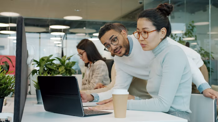 Two colleagues discussing an incident over a laptop